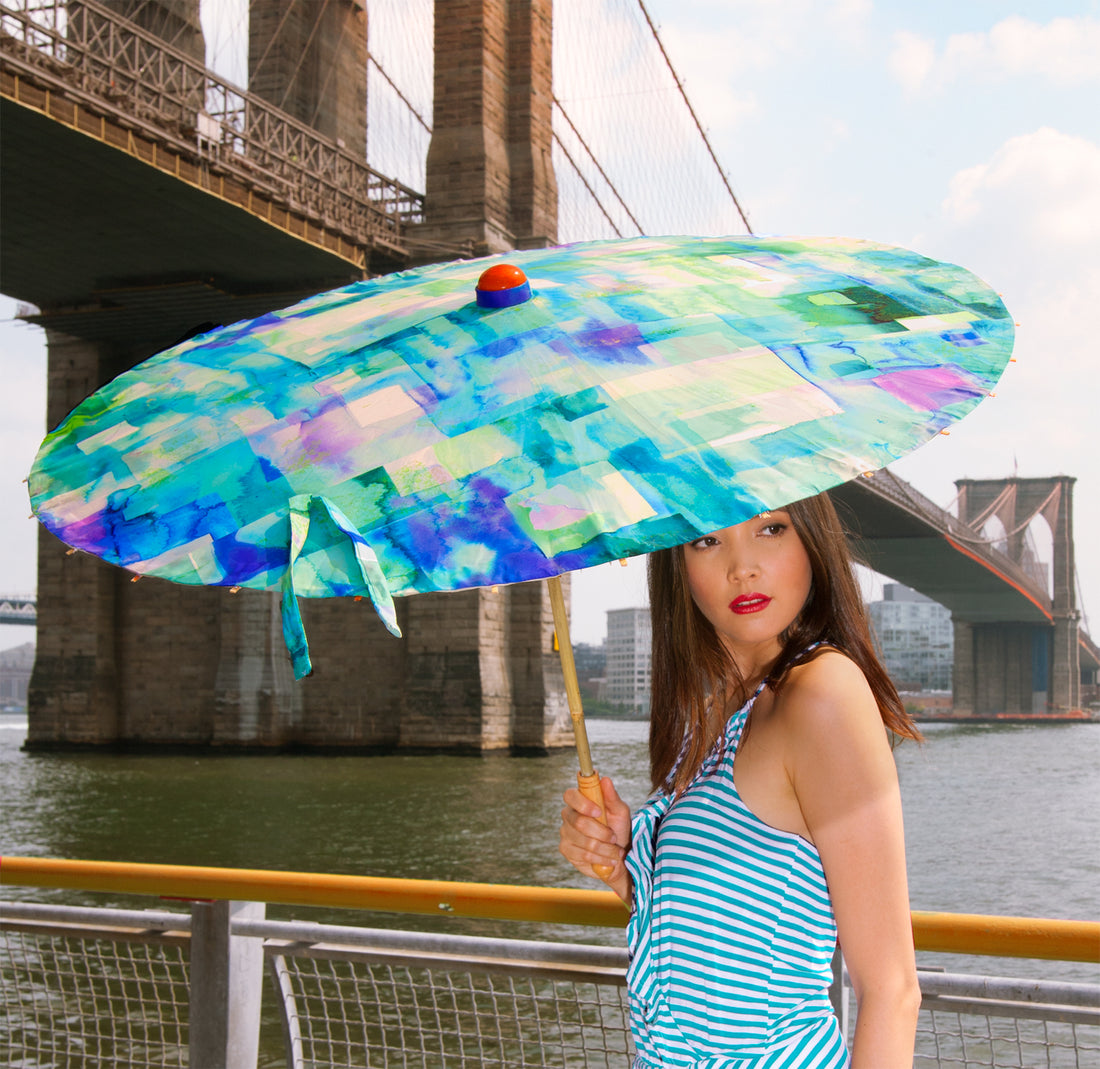 Woman holding Lily Lark Blue Squares handcrafted UV Sun Parasol